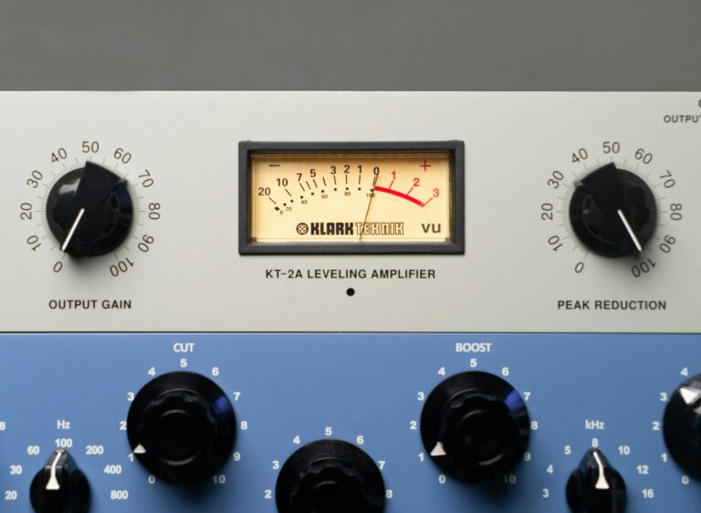 Close-up of a vintage KT-2A leveling amplifier with meter and knobs.